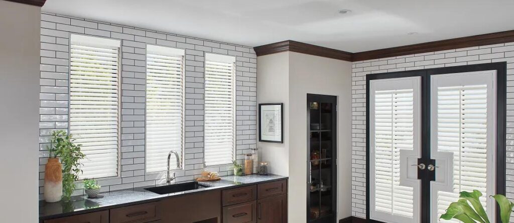 A kitchen with white brick walls and dark wood cabinets.