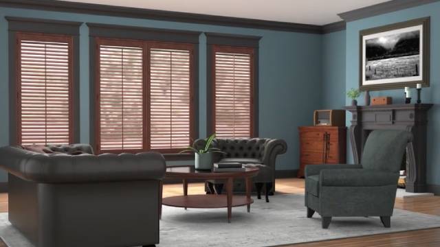 A living room with blue walls and brown furniture.