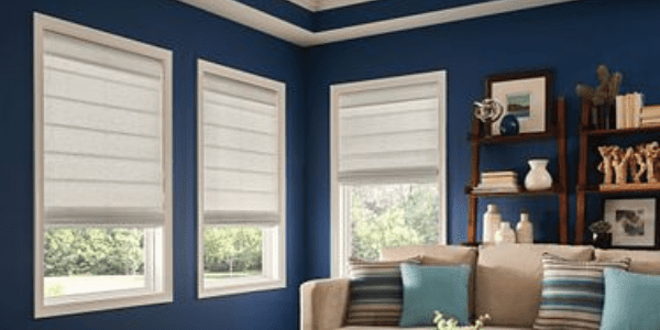 A living room with blue walls and white furniture.